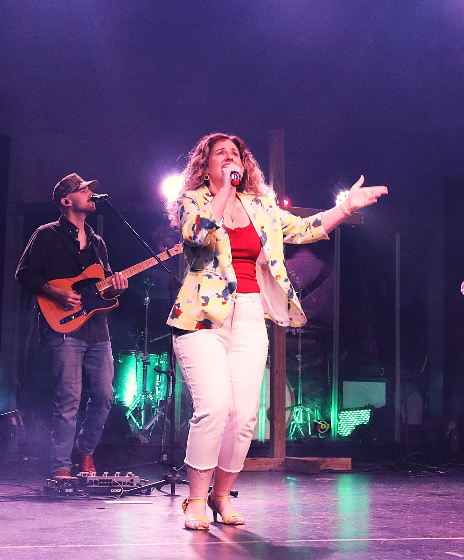 A worship leader singing at Next Level Church